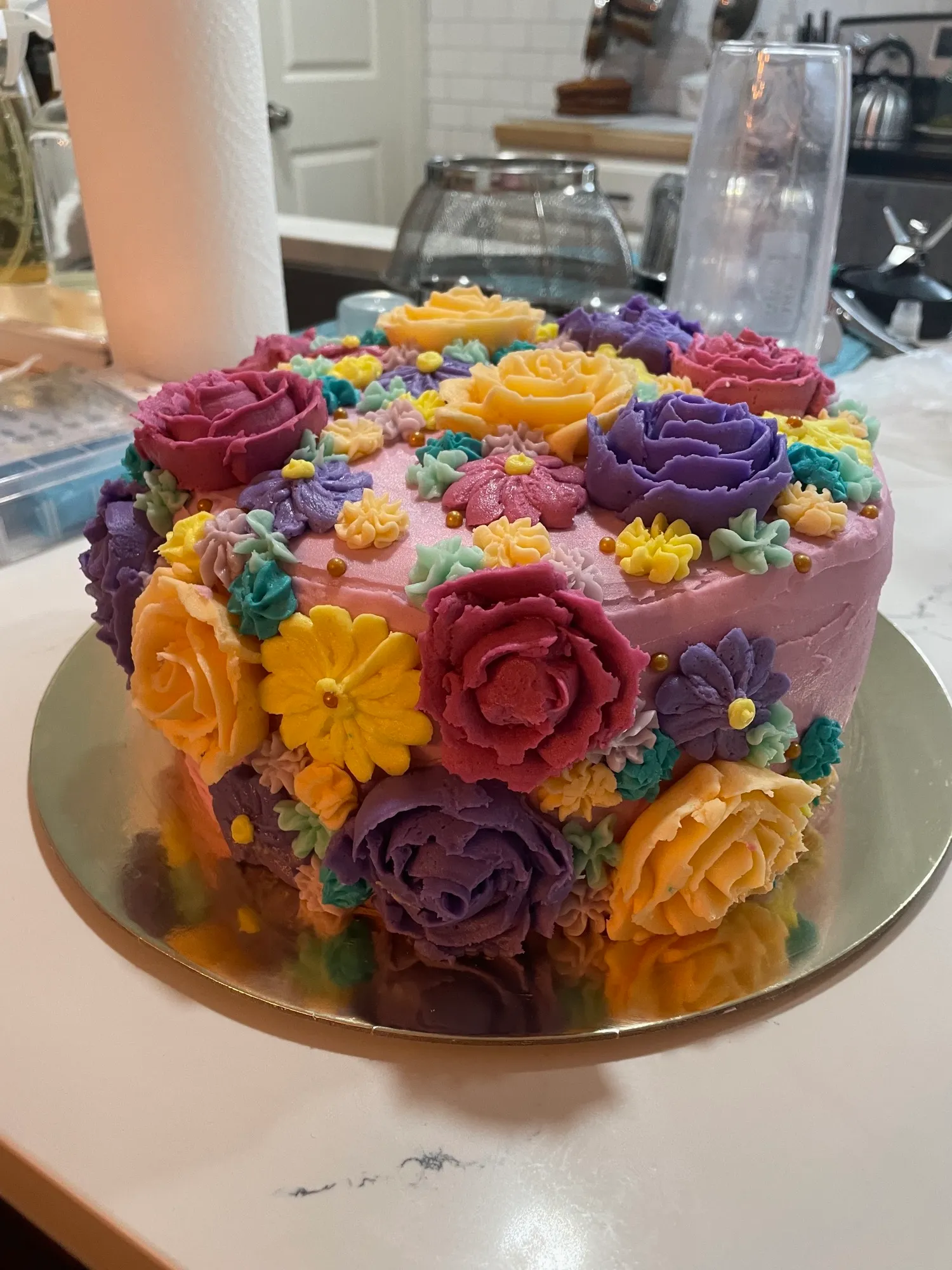 Colorful birthday cake covered in buttercream flowers
