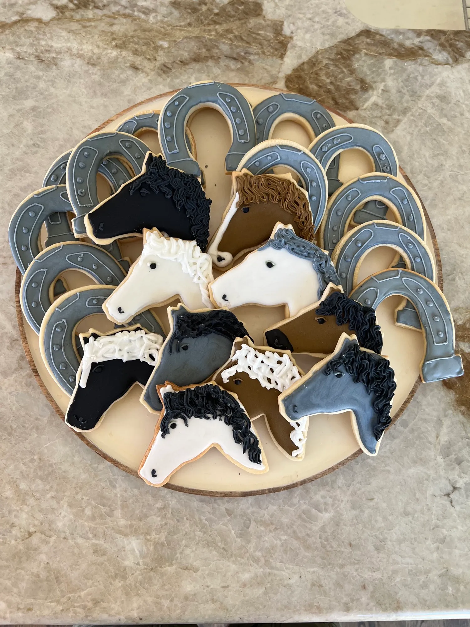 Custom decorated horse sugar cookies on a round board