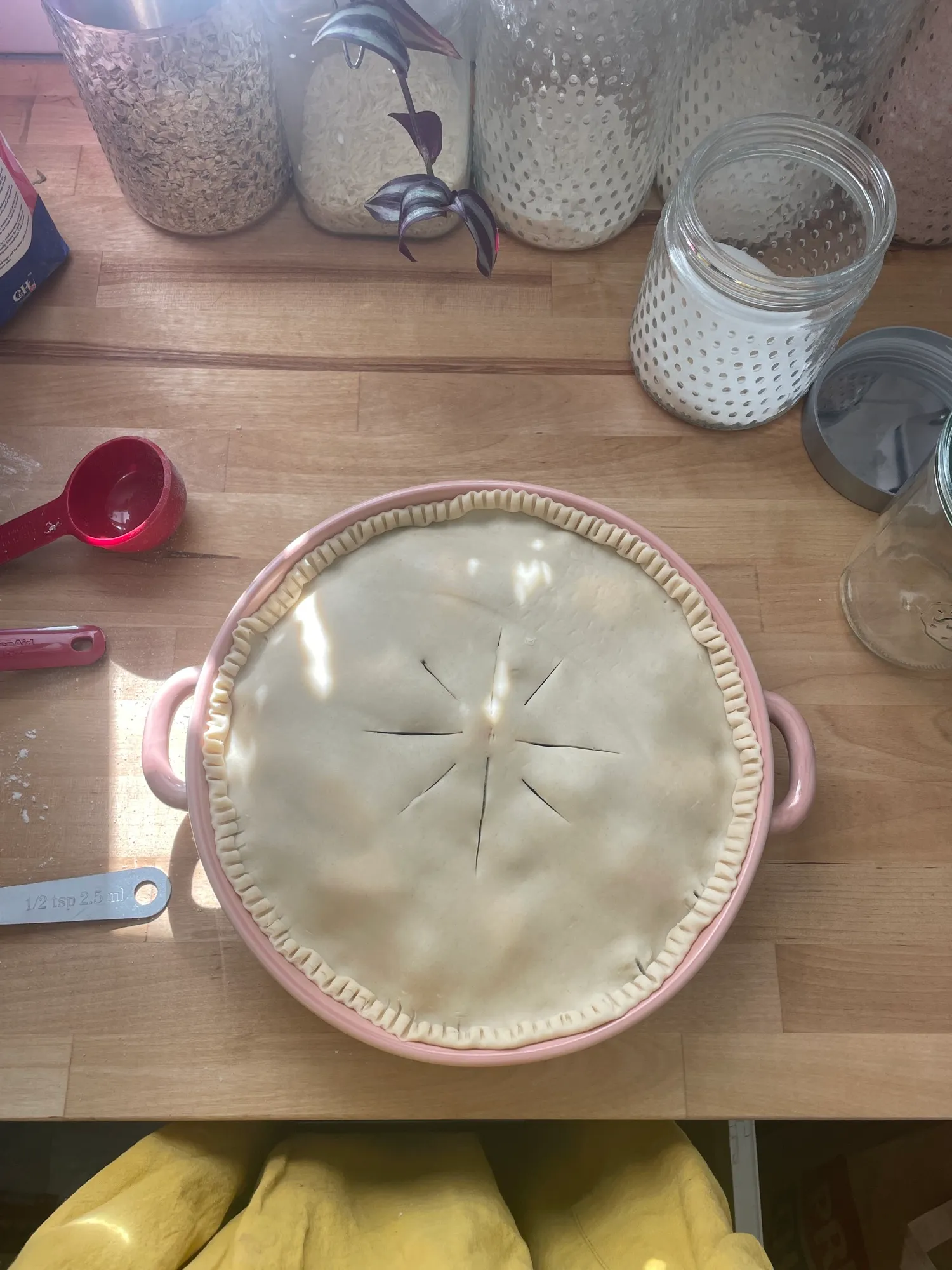 Unbaked pie in a pie dish with crimped crust
