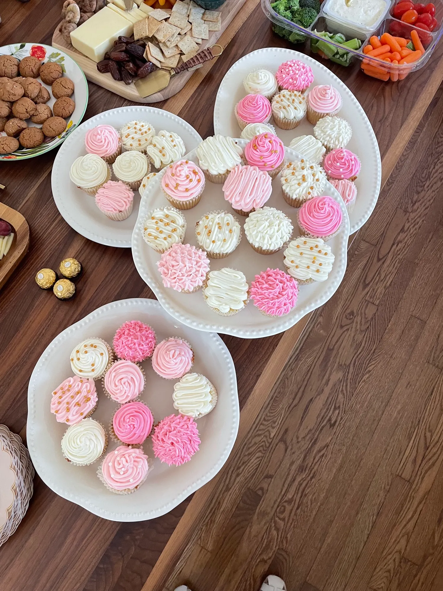 Pink frosted cupcakes on a platter