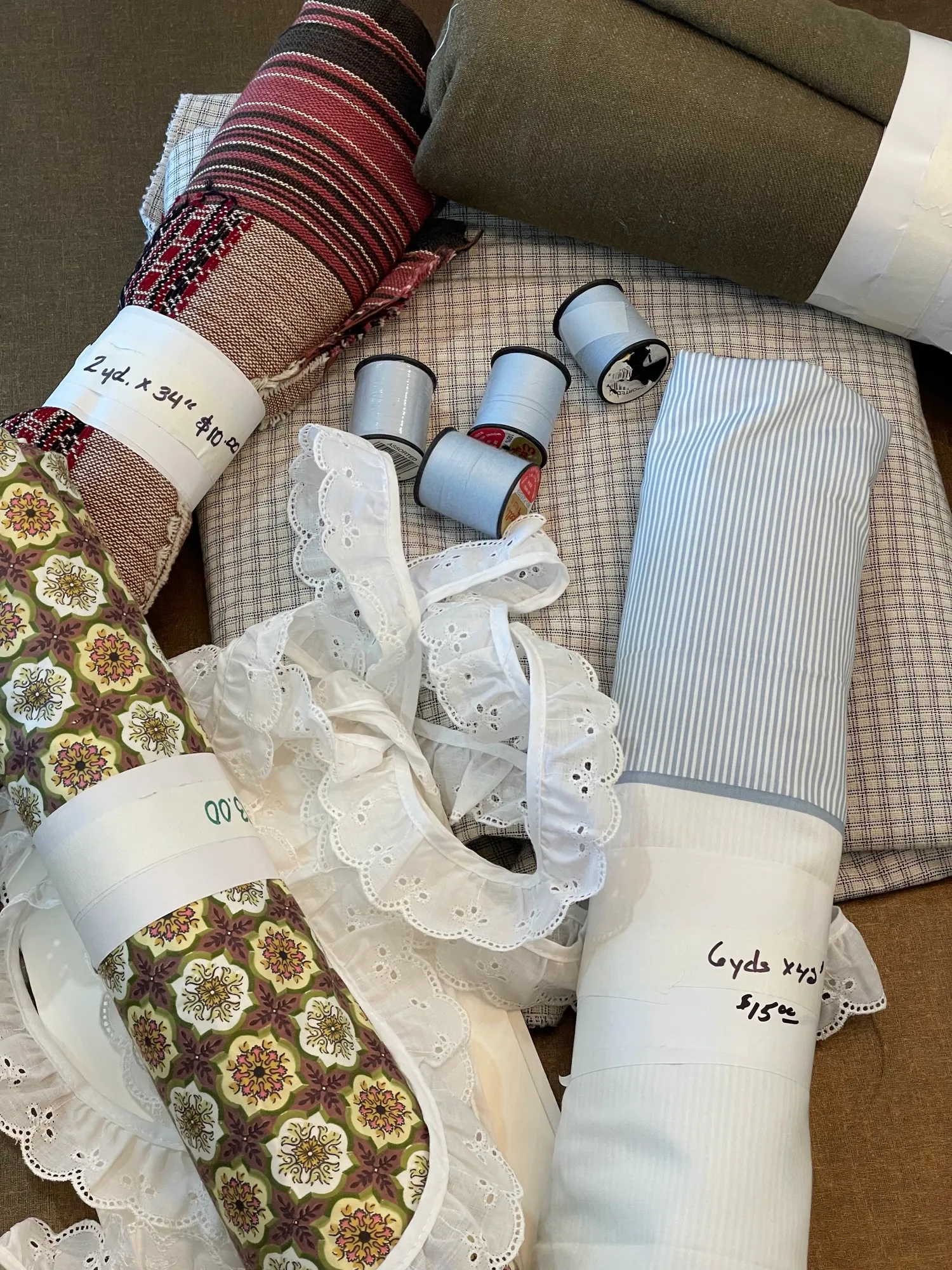 Fabric rolls, thread spools, and lace trim