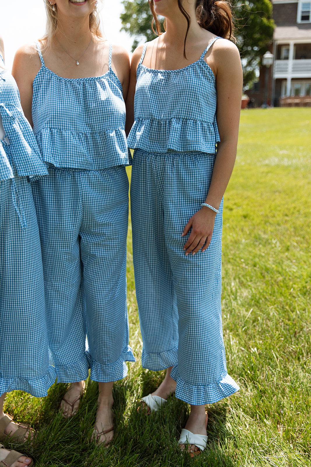 Women in gingham embracing