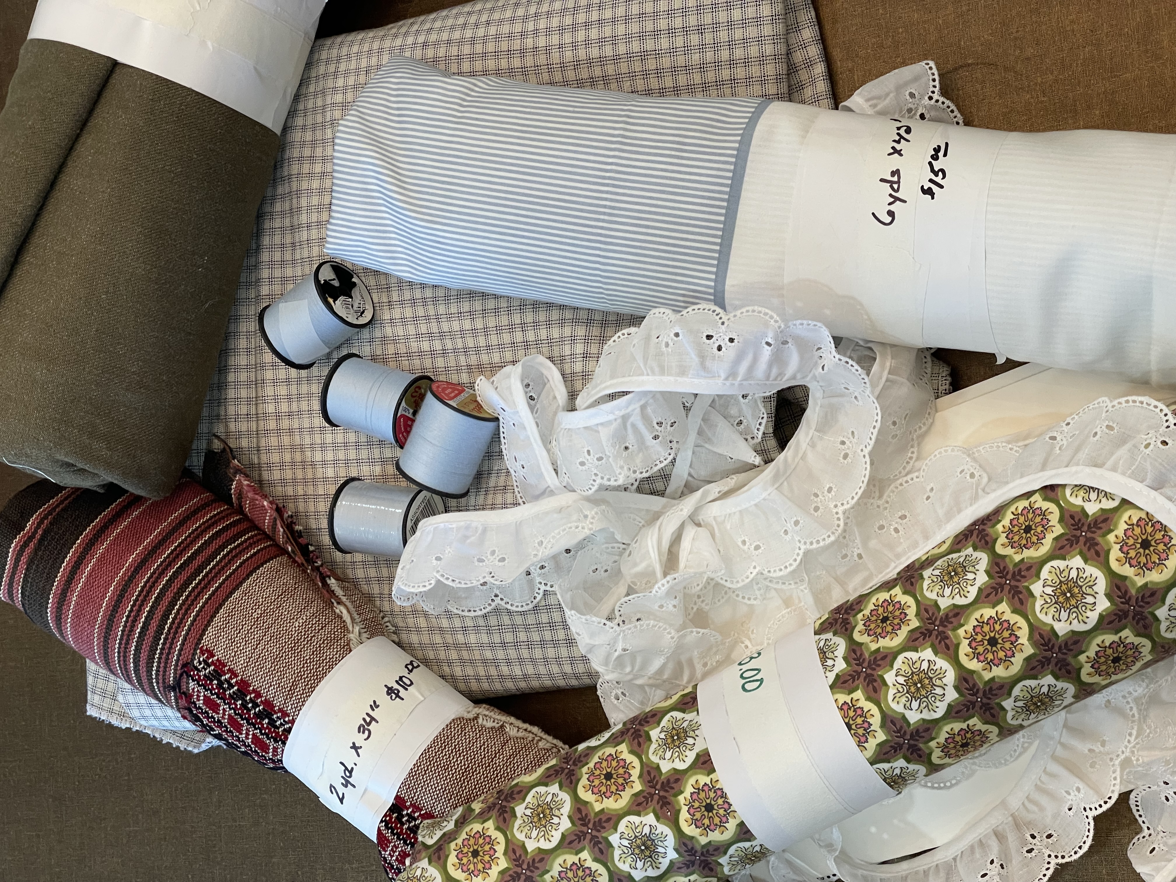 Fabric rolls, thread spools, and lace trim
